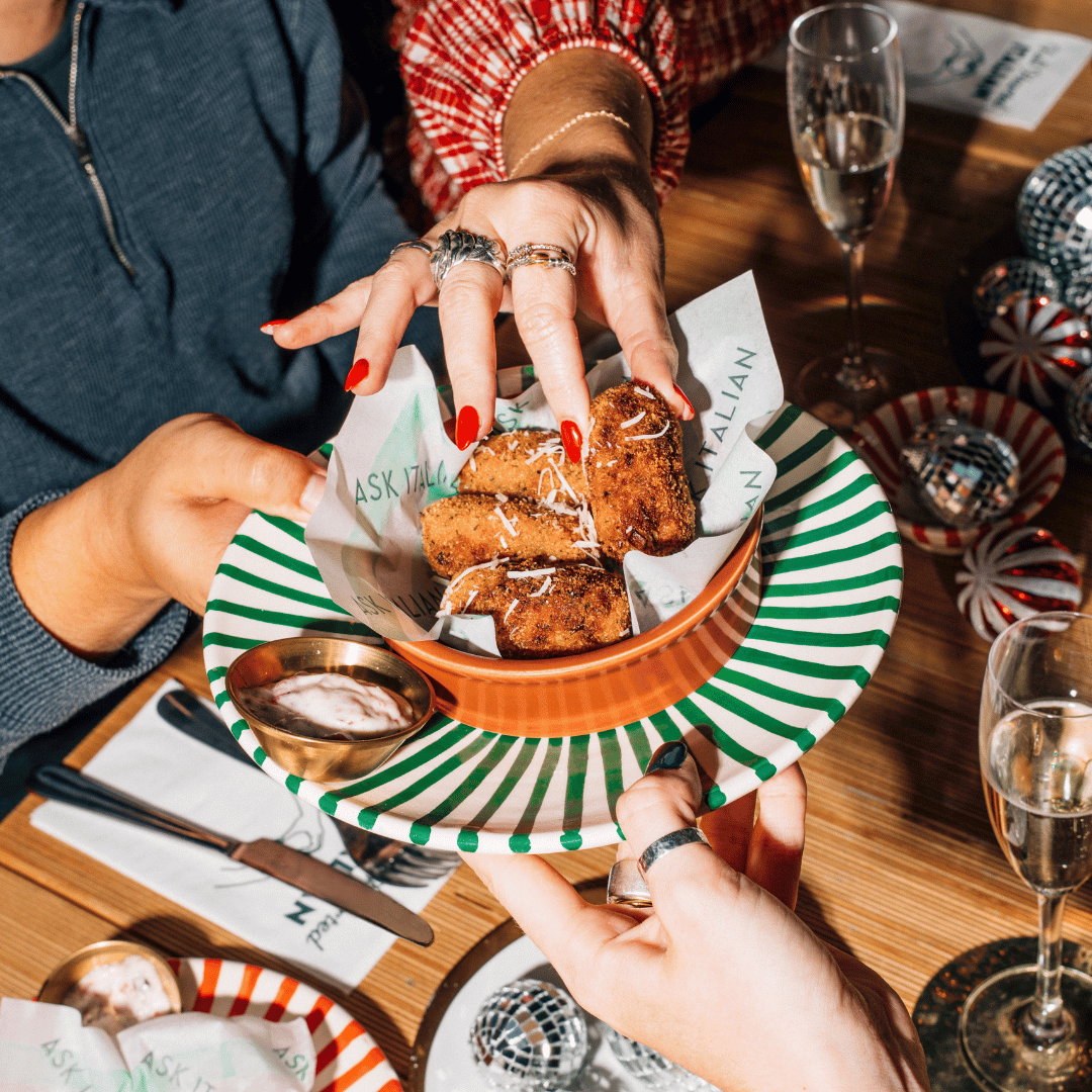 Somebody passing a plate with golden-brown Pancetta & Brussels Sprouts croquettes. 
