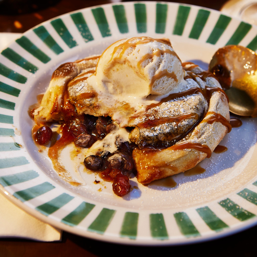 A sweet dessert calzone with melting vanilla gelato. The sweet mincemeat filling is oozing out of the middle. 